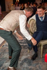 A volunteer is hypnotisted to steal shoes off this man's feet.